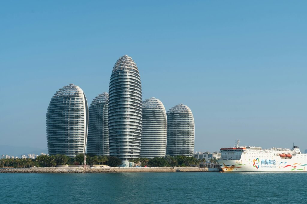 View of Phoenix Island's modern skyscrapers and cruise ship in Sanya, Hainan, China.